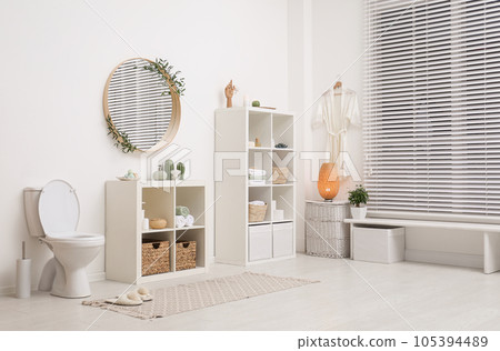 Interior of modern bathroom with round mirror 105394489
