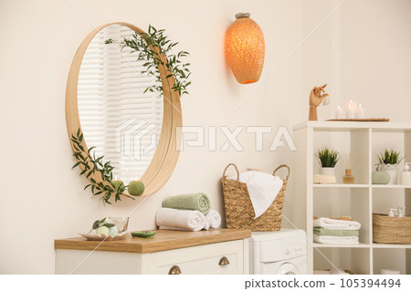 Round mirror on white wall in modern bathroom Round mirror on white wall in modern bathroom 105394494