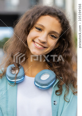 Happy preteen child kid smiling looking dreaming, resting, good news, feel satisfied in city street Happy preteen child kid smiling looking dreaming, resting, good news, feel satisfied in city street 105394568