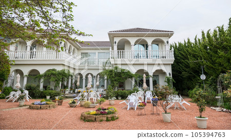 modern restaurant building with outdoor patio flower and tree decor 105394763