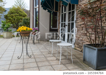 Coffee bakery cafe patio with minimal chairs and flower on pot Coffee bakery cafe patio with minimal chairs and flower on pot 105394764