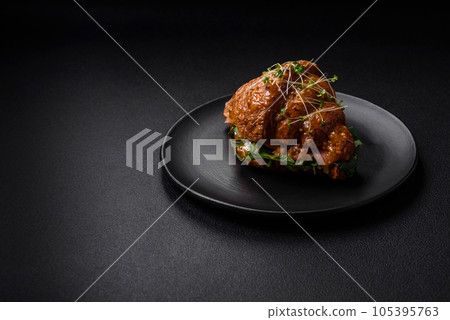 Delicious crispy croissant with salmon, lettuce, cheese and tomatoes Delicious crispy croissant with salmon, lettuce, cheese and tomatoes 105395763