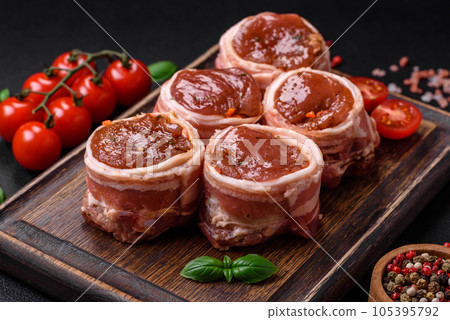 Delicious raw fresh pork or chicken meat rolls wrapped in bacon 105395792