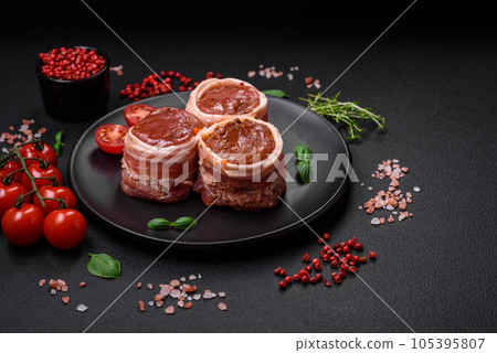 Delicious raw fresh pork or chicken meat rolls wrapped in bacon 105395807