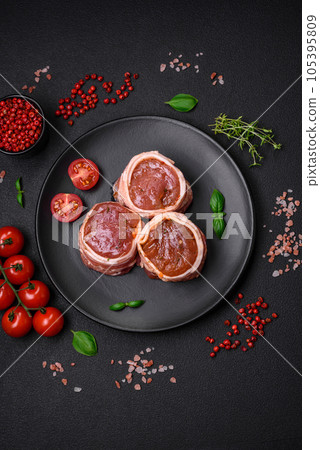 Delicious raw fresh pork or chicken meat rolls wrapped in bacon 105395809