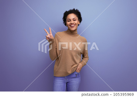 positive pretty young woman with dark skin and fluffy hair is happy over isolated background with 105395969