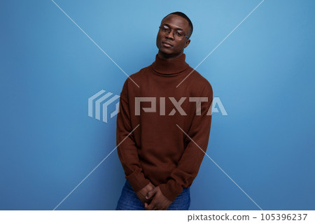 young american brunet man in stylish brown sweater over isolated blue background with copy space 105396237