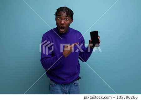 satisfied american young man with dreadlocks with a mobile phone pays the bill satisfied american young man with dreadlocks with a mobile phone pays the bill 105396266
