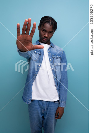 upset african man with curly hair in a casual look upset african man with curly hair in a casual look 105396276