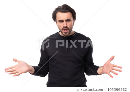young confused pleasant brunette man in a black sweater on an isolated white background 105396282