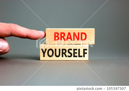 Brand yourself symbol. Concept words Brand yourself on beautiful wooden block. Beautiful grey table grey background. Businessman hand. Business brand yourself concept. Copy space. Brand yourself symbol. Concept words Brand yourself on beautiful wooden block. Beautiful grey table grey background. Businessman hand. Business brand yourself concept. Copy space. 105397307