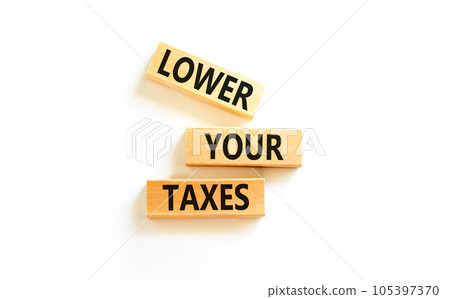 Lower your taxes symbol. Concept words Lower your taxes on wooden blocks on a beautiful white table white background. Business tax lower your taxes concept. Copy space. 105397370