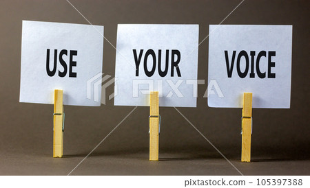 Use your voice symbol. Concept words Use your voice on white paper on a beautiful grey table grey background. Business and use your voice concept. Copy space. 105397388