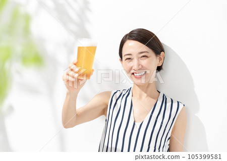A woman holding a beer A woman holding a beer 105399581