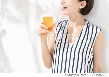 A woman holding a beer 105399709
