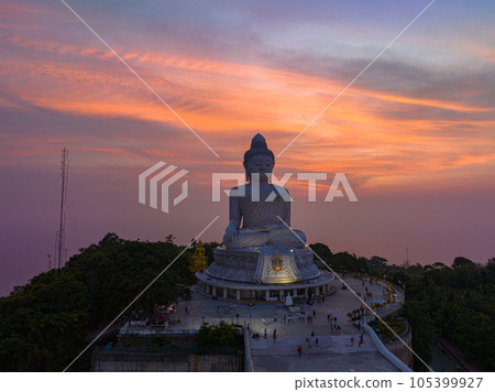 aerial view Phuket big Buddha in beautiful sunset..the sun shines through the clouds impact on ocean surface.The beauty of the statue fits perfectly with the charming nature..cloud scape background.. 105399927