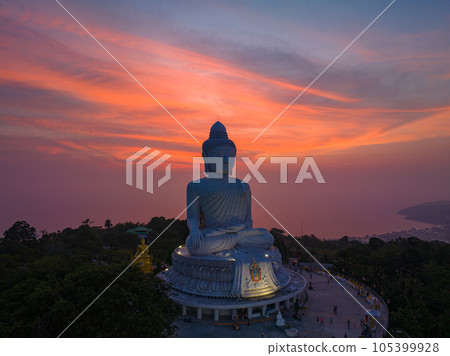 aerial view Phuket big Buddha in beautiful sunset. the sun shines through the clouds impact on ocean surface The beauty of the statue fits perfectly with the charming nature. cloud scape background. aerial view Phuket big Buddha in beautiful sunset. the sun shines through the clouds impact on ocean surface The beauty of the statue fits perfectly with the charming nature. cloud scape background. 105399928