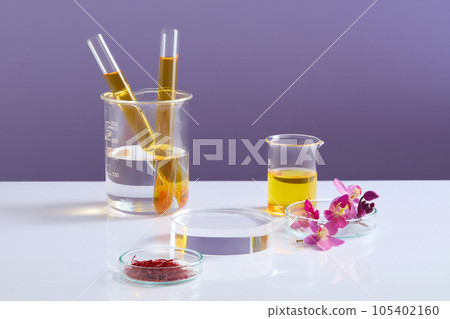 Transparent podium placed in the middle of several laboratory glassware against purple background. Saffron could boost your health or help with specific health issues 105402160