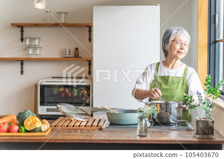 Asian senior / elderly woman cooking in the kitchen at home (smile) Asian senior / elderly woman cooking in the kitchen at home (smile) 105403670