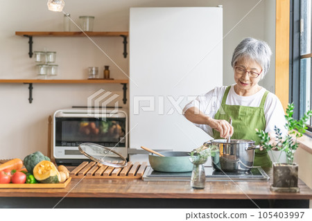 Asian elderly woman cooking in the kitchen at home (smile) Asian elderly woman cooking in the kitchen at home (smile) 105403997