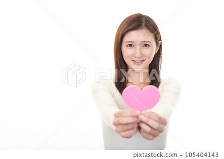 A woman with a heart-shaped object A woman with a heart-shaped object 105404143