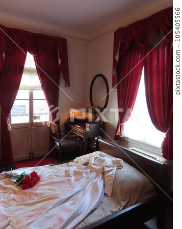 Kobe Kitano Ijinkan, Kaori no Yakata, bedroom in Holland pavilion, white dress spread on the bed, and a bouquet of red roses on it 105405566
