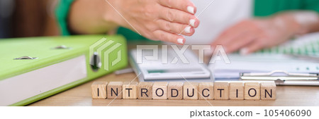 Manager invites for handshaking at desk with financial documents and letters introduction on cubes. 105406090