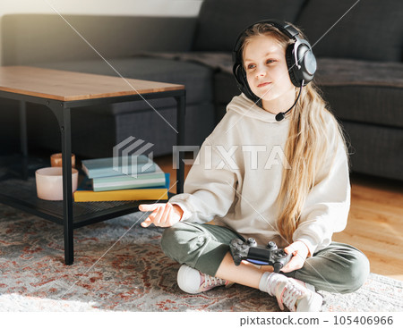 Little girl playing on games console 105406966