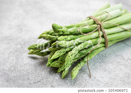 Fresh green asparagus on concrete background. Fresh green asparagus on concrete background. 105406971