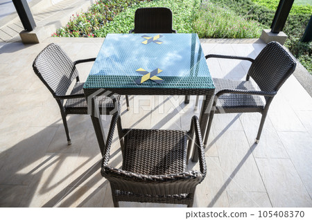 The marking on empty wooden table without nobody. Keep spaced between each chairs make separate for social distancing to avoid spreading of Covid-19. Social distance concept. 105408370