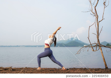 Lifestyle woman worm up raise arm before pose for healthy life.  105408450