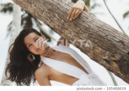 Luxury Vacation of Beach Fashion Woman Model in Stylish White Modern Swimwear 105408639