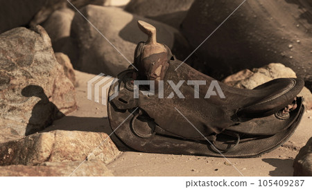 very old horse saddle on sand beach 105409287
