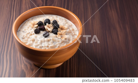 Healthy overnight oat topping with fresh fruit on table. 105409483