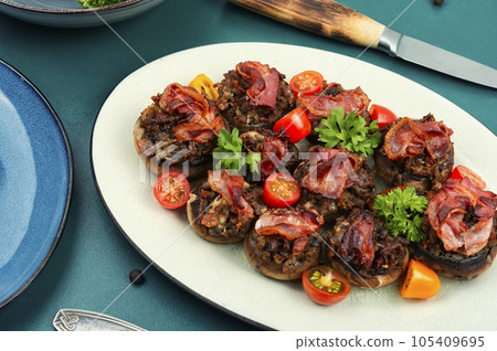 Stuffed mushrooms caps on plate. Stuffed mushrooms caps on plate. 105409695