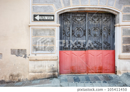 Street view of an old building facade with metal gate, architecture background, Latacunga, Ecuador. 105411450