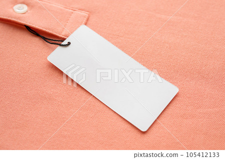 Blank white clothes tag label on pink fabric texture background Blank white clothes tag label on pink fabric texture background 105412133