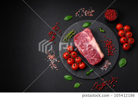 Fresh raw beef striploin steak with salt, spices and herbs 105412186