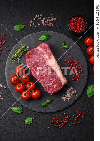 Fresh raw beef striploin steak with salt, spices and herbs 105412188