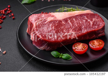 Fresh raw beef striploin steak with salt, spices and herbs Fresh raw beef striploin steak with salt, spices and herbs 105412197