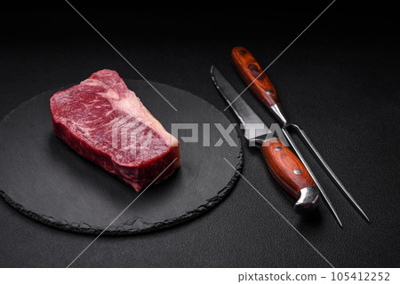 Fresh raw beef striploin steak with salt, spices and herbs Fresh raw beef striploin steak with salt, spices and herbs 105412252