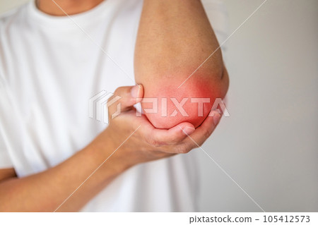 Young man feeling pain in elbow healthcare concept Young man feeling pain in elbow healthcare concept 105412573