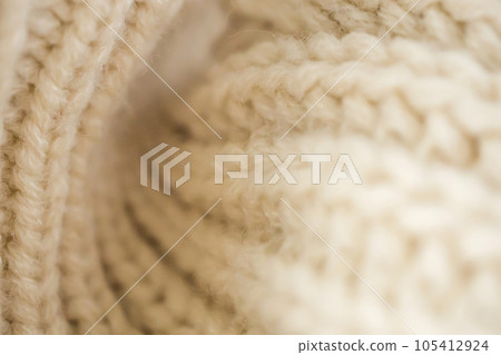 closeup beige knitted woolen fabric background closeup beige knitted woolen fabric background 105412924