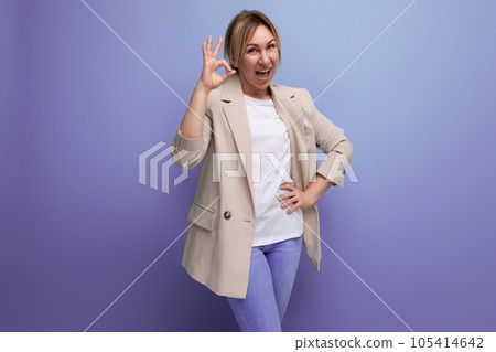 positive confident blonde young adult in jacket showing class on studio background with copy space 105414642
