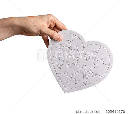 Hand holding heart puzzle isolated on white background. Donation, love, charity concept Hand holding heart puzzle isolated on white background. Donation, love, charity concept 105414670