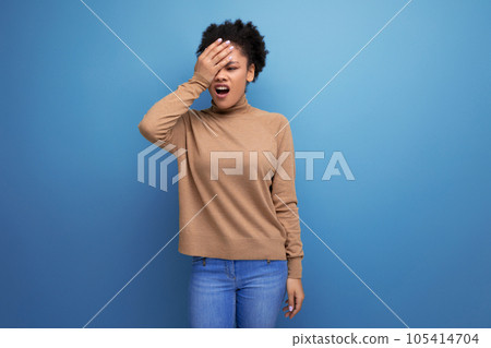 young attractive latin woman with black afro hair pulled back in ponytail isolated on background young attractive latin woman with black afro hair pulled back in ponytail isolated on background 105414704