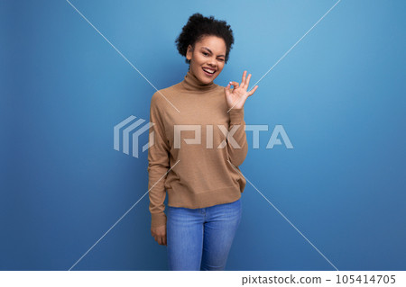 young optimistic latin woman with curly hair smiling on background with copy space young optimistic latin woman with curly hair smiling on background with copy space 105414705