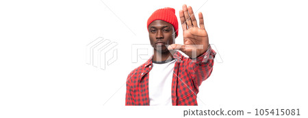 doubtful young american man in red cap and plaid shirt on white background with copy space 105415081