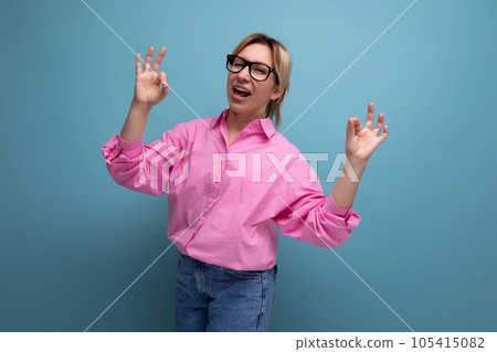 pretty young blond european woman model with ponytail hairstyle in stylish look consisting of pink 105415082