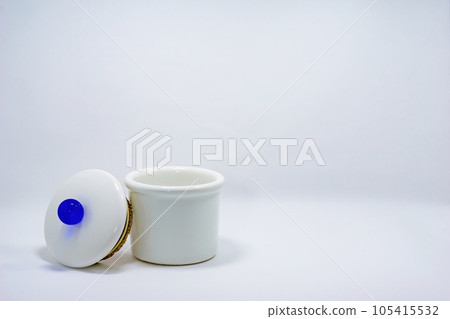 White pottery pot with lid with blue knob 105415532